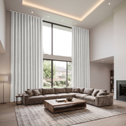 Off-White Velvet S-Fold Extra Long Curtains in a Modern Double-Height Living Room with Floor-to-Ceiling Windows, Light Wood Flooring, and a Gray Rug