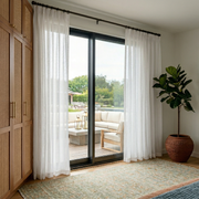 Off-White Voile Linen Pinch Pleat Curtains for Sliding Doors in a Bedroom with Cream Walls