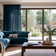 Peacock Blue Linen Back Tab Extra Long Curtains in a Contemporary Living Room with Blue Sectional Sofa and Garden View