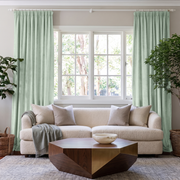Mint Green Velvet Pencil Pleat Curtains in a Bright Living Room with Soft White Walls and a Cream Bouclé Sofa
