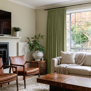 Olive Green Velvet Pencil Pleat Curtains in a Contemporary Living Room with Cream Walls and Cognac Leather Chairs