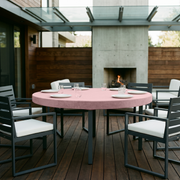 Pink Fitted Velvet Round Tablecloth in a Modern Patio Dining Space with Gray Metal Chairs and Dark Wood Accents