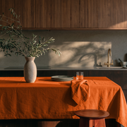 Burnt Orange Rectangular Linen Tablecloth in a Modern Organic Kitchen with Fluted Wood Cabinets