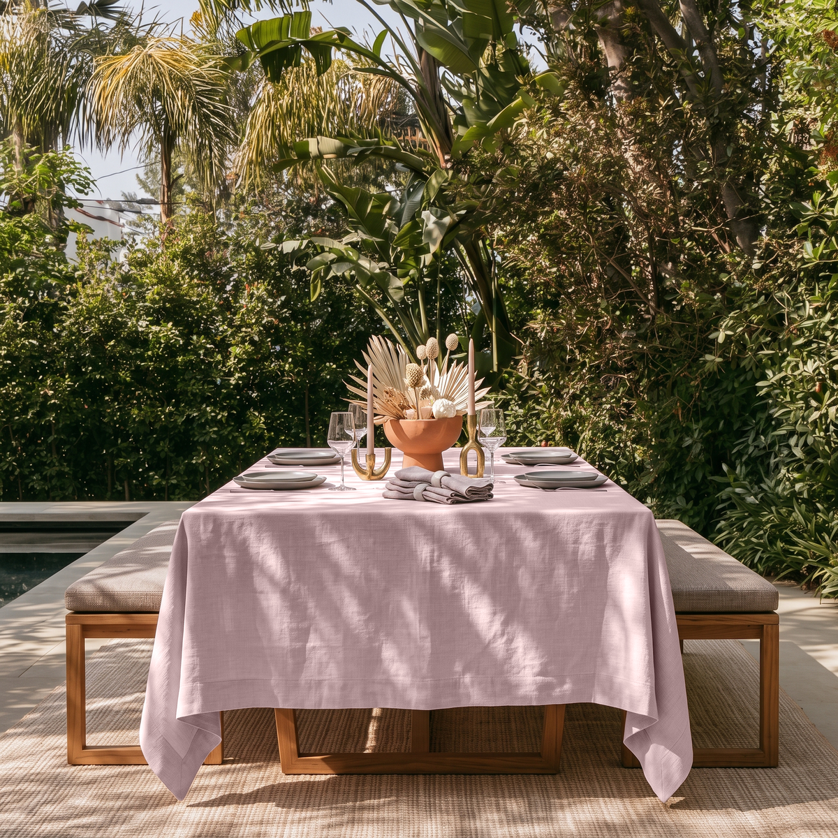Dusty Pink Rectangular Linen Tablecloth in a Tropical Outdoor Dining Area with Wooden Bench Seating