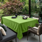 Light Green Rectangular Velvet Tablecloth in a Contemporary Patio Dining Area with Woven Chairs and Lush Garden Views