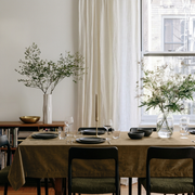 Olive Brown Rectangular Velvet Tablecloth in a Contemporary Dining Room with Black Chairs and Sheer White Curtains