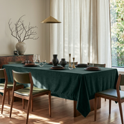 Hunter Green Rectangular Velvet Tablecloth in a Mid-Century Modern Dining Room with Olive Green Chairs and Cream Curtains