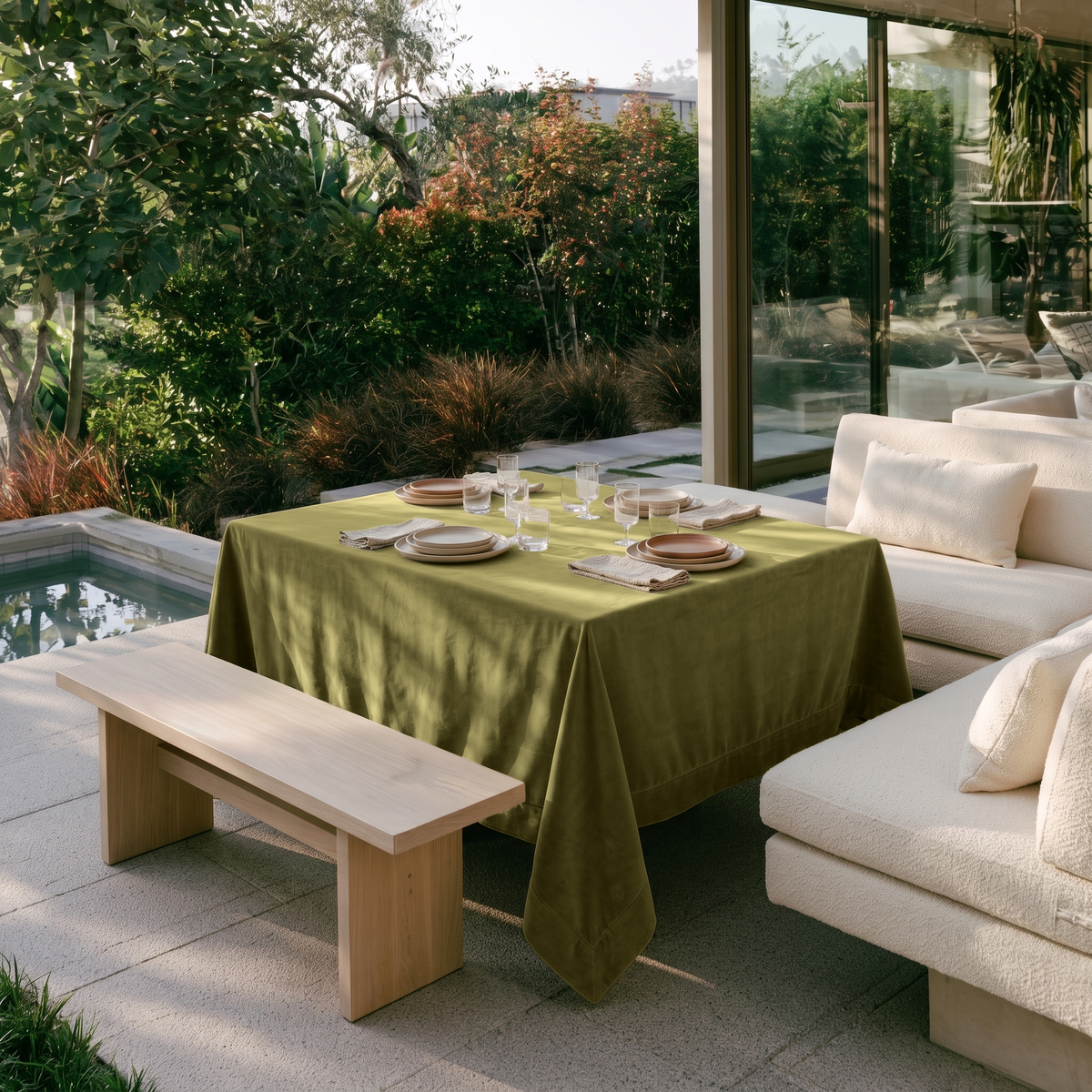 Moss Green Rectangular Velvet Tablecloth in a Contemporary Patio Dining Area with Cream Sofas and Wooden Bench