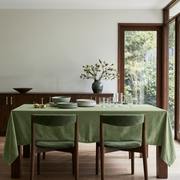 Sage Green Rectangular Velvet Tablecloth in a Mid-Century Modern Dining Room with Green Upholstered Chairs and Walnut Sideboard