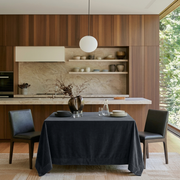 Steel Black Rectangular Velvet Tablecloth in a Contemporary Kitchen with Walnut Cabinetry and Black Leather Chairs