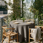 Natural Heavy Weight Linen Round Tablecloth in a Balcony Dining Space with Glass Railings and Light Wood Chairs
