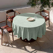 Mint Green Round Velvet Tablecloth in an Outdoor Dining Area with Stone Flooring and Walnut Chairs Accents