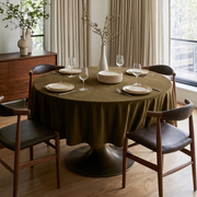 Olive Brown Round Velvet Tablecloth in a Dining Room with Beige Drapes and Dark Leather Chairs