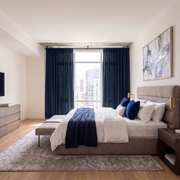 Royal Blue Linen Back Tab Extra Long Curtains in a Contemporary Bedroom with Upholstered Bed, a Textured Beige Rug and City View 