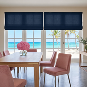 Royal Blue Linen Cordless Roman Blinds in a Coastal Dining Room with Beige Walls, a Light Wood Dining Table and Pink Velvet Chairs.