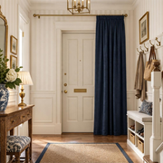 Royal Blue thermal door curtains in a Hallway with Off-White Striped Walls and a white front door.
