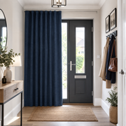 Royal Blue thermal door curtains in a Hallway with Off-White Walls and a dark grey front door.