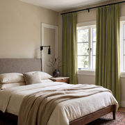 Moss Green Velvet S-Fold Curtains in a Minimal Bedroom with Cream Walls and White Bedding
