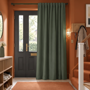 Sage Green Thermal Door Curtain in a Hallway with Rust Orange Walls 