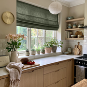 Sage Green Linen Roman Blinds in a Cozy Kitchen with Open Wood Shelving - Cotton Lining