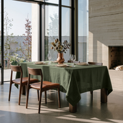 Sage Green Rectangular Linen Tablecloth in a Contemporary Dining Room with Floor-to-Ceiling Windows and Concrete Fireplace
