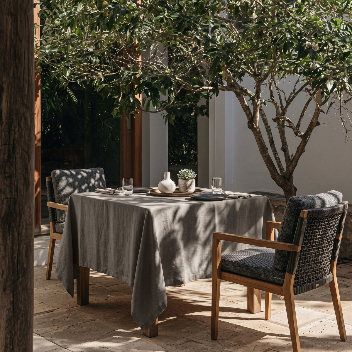 Natural Square Heavy Weight Linen Tablecloth in an Outdoor Dining Area with Woven Chairs