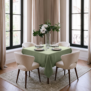 Asparagus Green Square Linen Tablecloth in a Transitional Dining Room with White Upholstered Chairs