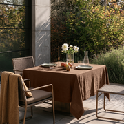 Tawny Brown Square Linen Tablecloth on a Contemporary Garden Patio with Woven Chairs