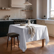 White Square Linen Tablecloth in a Modern Farmhouse Kitchen with Black Cabinetry and Pendant Light