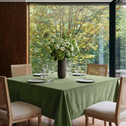 Sage Green Square Velvet Tablecloth in a Mid-Century Modern Dining Room with Floor-to-Ceiling Windows and Cane Chairs
