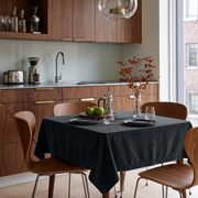 Steel Black Square Velvet Tablecloth in a Modern Kitchen with Walnut Cabinetry