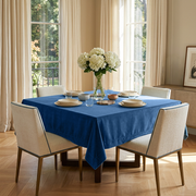 Steel Blue Square Velvet Tablecloth in a Transitional Dining Room with Cream Upholstered Chairs