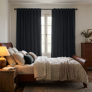Steel Black Velvet Back Tab Extra Long Curtains in a Traditional Bedroom with Wooden Bed and Warm Bedside Lighting