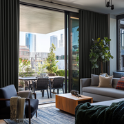 Steel Black Velvet S-Fold Blackout Curtains for Sliding Doors in a Living Room with Light Grey Walls