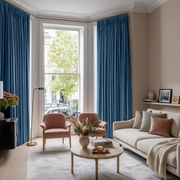 Steel Blue Velvet Pencil Pleat Blackout Curtains in a Living Room with Beige Walls