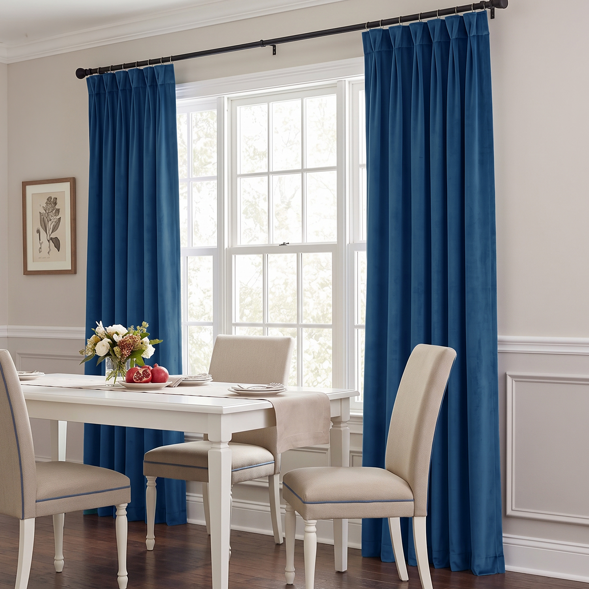 Bright dining room with blue curtains, a white table, and beige chairs.
