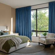 Steel Blue Velvet Rod Pocket Blackout Curtains in a Bedroom with Beige Walls