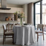 Stone Grey Linen Round Tablecloth in a Contemporary Kitchen Dining Space with Taupe Curtains and Grey Upholstery