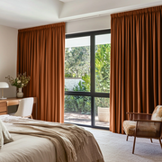 Terracotta Linen Pencil Pleat Curtains in a Bright Bedroom with Natural Wood Furniture - Blackout Lining