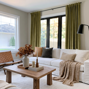 Moss Green Velvet Back Tab Curtains in a Modern Living Room with a White Sofa and Woven Leather Chair