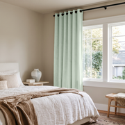 Mint Green Velvet Eyelet Curtains in a Minimal Bedroom with White Bedding and a Cane Bench
