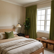 Moss Green Velvet Pencil Pleat Curtains in a Cozy Bedroom with Beige Bedding and a Rattan Headboard