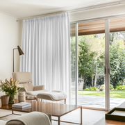 White Linen Pencil Pleat Curtains for Bifold Doors in a Living Room with Cream Walls - Cotton Lining
