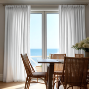 White Linen Pinch Pleat Dining Room Curtain in a Coastal Dining Room with Light Grey Walls, Woven Rattan Chairs and an Ocean View - Cotton Lining